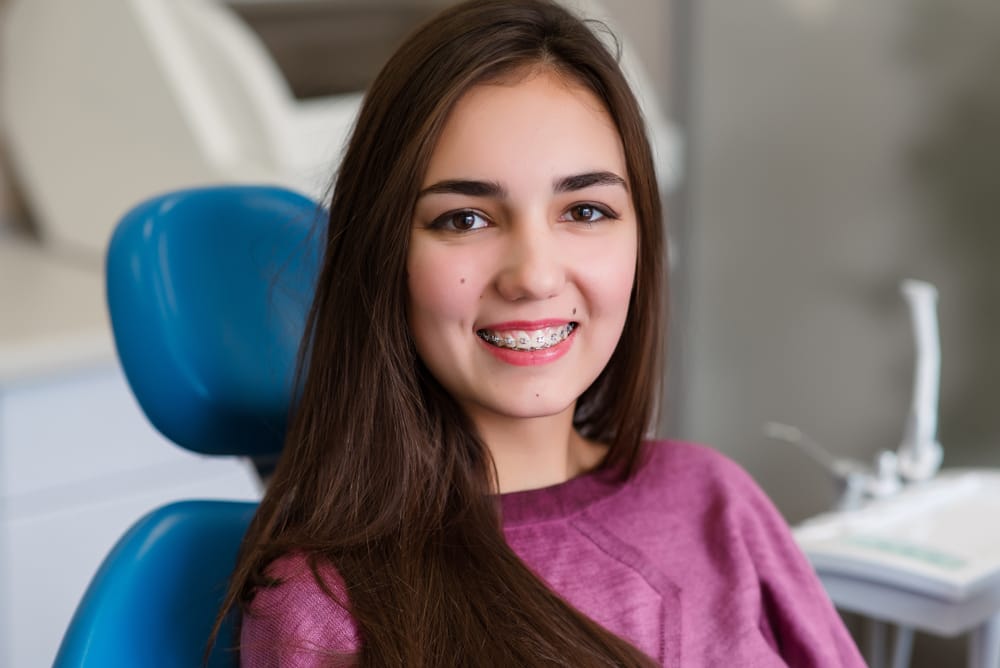 woman with braces - dental bonding woman with braces - dental bonding