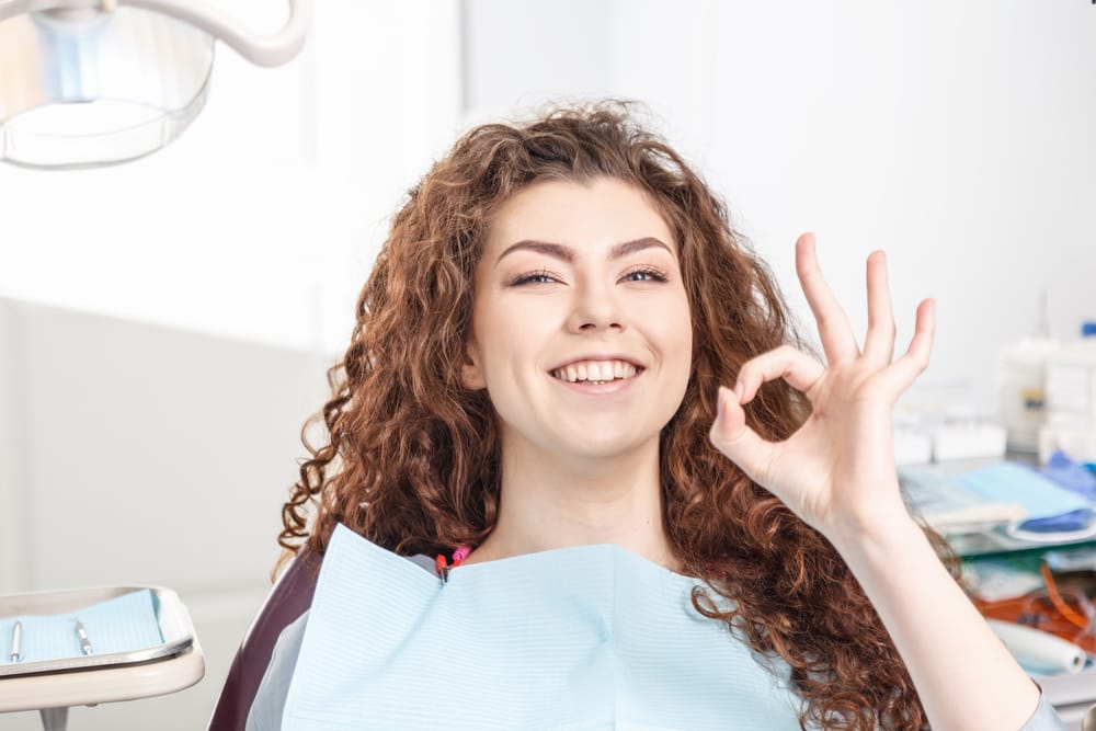 Dentist OK beauty woman show in dentist office - Dental Crowns in Carmel Valley