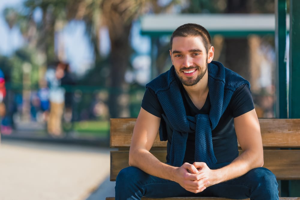 man sitting at the park - veneers man sitting at the park - veneers