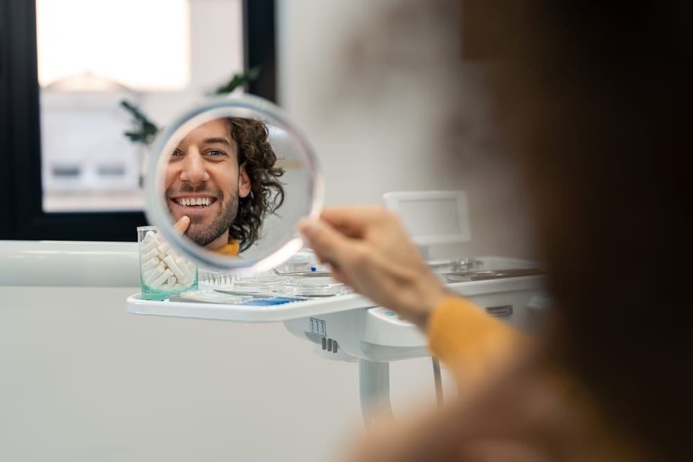 Man checking his teeth - Dental Cleaning Man checking his teeth - Dental Cleaning