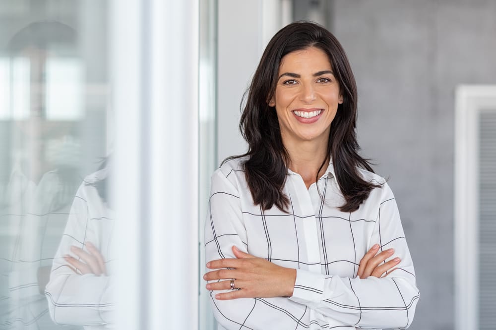 businesswoman in modern office looking at camera - Dental Sealants