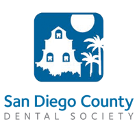 Logo of the San Diego County Dental Society featuring a white building, palm trees, and a sun within a blue square - Carmel Valley Dental Logo of the San Diego County Dental Society featuring a white building, palm trees, and a sun within a blue square - Carmel Valley Dental